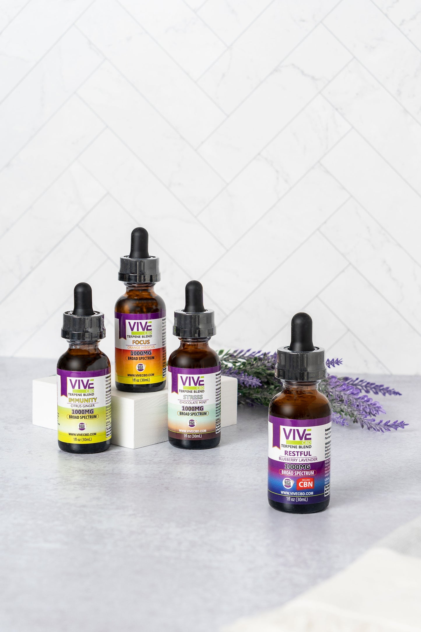 A serene arrangement of various CBD products on a wooden table, including CBD oil, gummies, a roll-on, honey sticks, a bath bomb, and a pet tincture, surrounded by hemp leaves and lavender flowers.